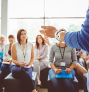 A group of people in front of a compliance trainer