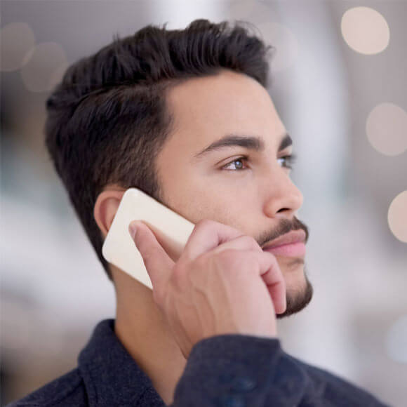 a man talking on the phone on a compliance policy hotline